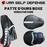 Patte d'ours courbée de boxe ambidextre de couleur noir et blanche avec liseré blanc. Haute densite de mousse et fixation par scratch.